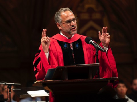 Adam Falk delivering his talk in academic robes