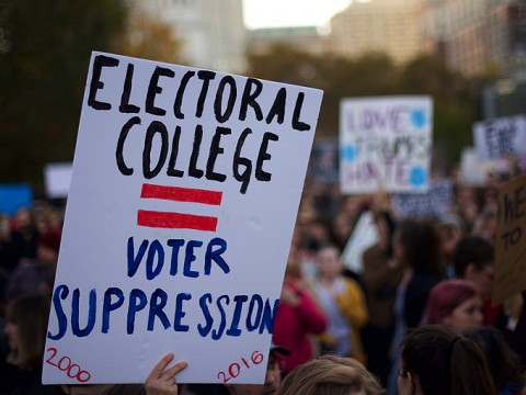 A protester holding a sign that reads "ELECTORAL COLLEGE = VOTER SUPPRESSION" on November 13, 2016.