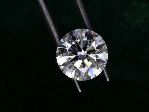 Diamond held by metal tongs
