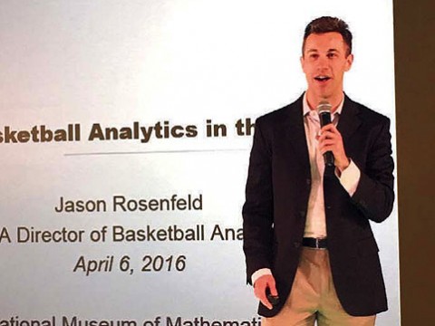 Jason Rosenfeld delivers a presentation with microphone in hand