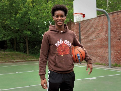 Ibrahim Barry with a basketball on a court