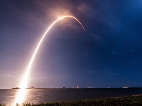 A time-lapse exposure of the SpaceX rocket carrying TEMPO into orbit reveals an arc of light against the sky.
