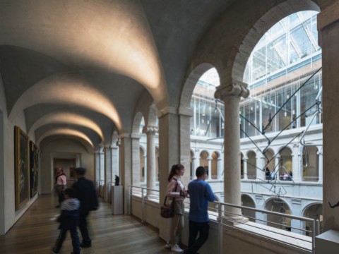 A few visitors in the arcade overlooking the Calderwood Courtyard of the Harvard Art Museums