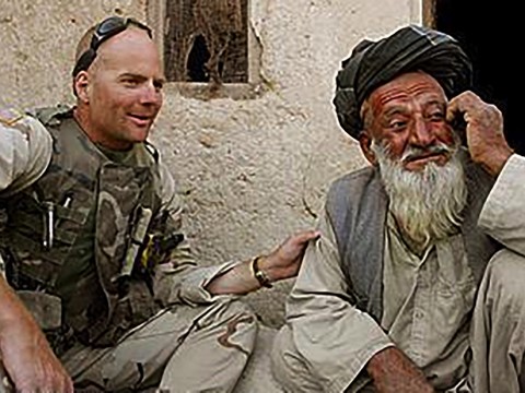 Photograph of Kit Parker on duty in Afghanistan, spring 2003, with a village leader in Kandahar Province