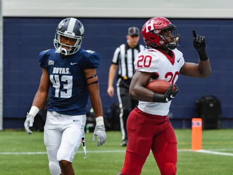 Harvard junior Aaron Shampklin (20) singed Georgetown defenders such as Jonathan Honore for 186 yards and two touchdowns.