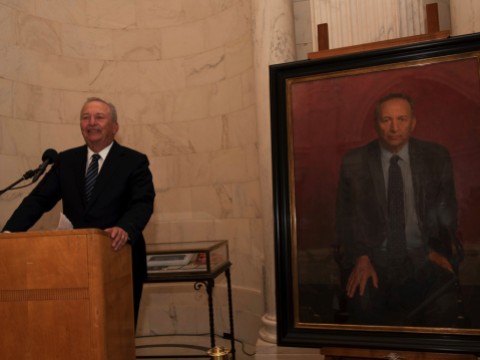 Lawrence H. Summers at the lectern next to his official portrait