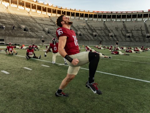 Harvard football players limbering up for season-opening game
