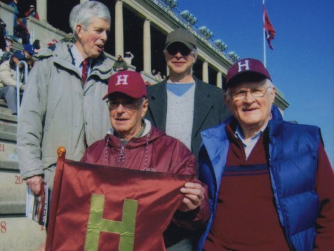 Paul Lee (left) holds the Little Red Flag replica in 2012. Also shown (clockwise from top left) are Spencer Ervin, Jeffrey Lee, and Stephen Goodhue.