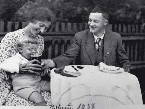 Black-and-white photograph of Karl Puchner in 1937 with his wife, young son, and a tiny, barely visible swastika button on his jacket