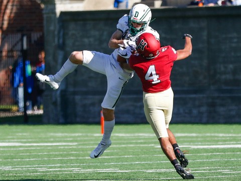 Harvard defensive back Max Jones knocks a ball out of the hands of Dartmouth wide receiver Drew Estrada