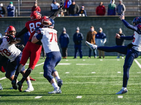 Penn's kicker, Jake Haggard, punts the football.