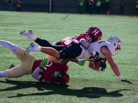  Harvard’s Truman Jones (90) and Khalil Dawsey corral Yale running back Joshua Pitsenberger. 
