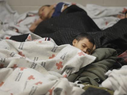 Detainees sleep in a holding cell at a U.S. Customs and Border Protection processing facility on Wednesday, June 18, 2014, in Brownsville, Texas. The CPB provided media tours that day of two locations in Brownsville and Nogales, Arizona, that have been central to processing the more than 47,000 unaccompanied children who have entered the country illegally since last October 1.