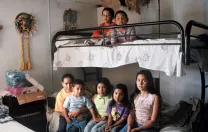 Seven Mexican immigrant children inside an old mobile home, where they live with their single mother in Mission, Texas