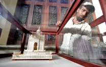 It was important to Princess Esra that the restored palace tell the story of the Asaf Jah dynasty. Here, a worker cleans a historical display.