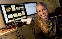 Historian Jo Guldi in her office at the Society of Fellows. She uses visualizations such as those shown behind her to aid her research.