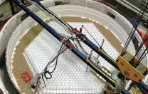 At the Steward Observatory Mirror Lab, in Tucson, staff load the rotary kiln with hexagonal columns of refractory material.