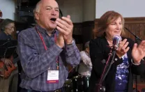 Chris Mortenson and his wife, Winnie, applaud an open-mic music session