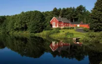 Iconic red-painted River Bend Farm Visitor Center by the Blackstone River and canal