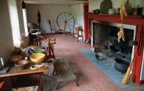 Open hearth, spinning wheel, and other elements in the colonial-era Sylvanus Brown House in Pawtucket, Rhode Island