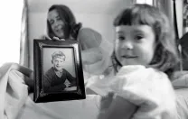 Eve, foreground, and her grandmother, with a fifth-grade photo of Geoffrey