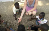 Betancourt engages Sierra Leonean children in a counting game.