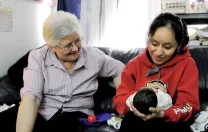 In East Harlem, Susana Saldivar and her son Xavier receive a visit from Sister Suzanne Deliee, a nurse with Little Sisters of the Assumption Family Health Service.