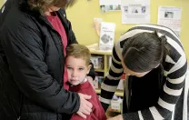 In Dorchester, Liam Denver has a hard time saying goodbye to his mother, Kim, as teacher Carolyn Christopher offers comfort.