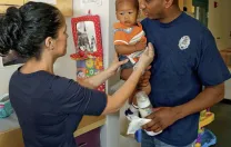 In Dorchester, Amos Monteiro leaves his son, Desmond, with teacher Stella Ortiz.