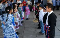 Children perform "cuecas," a Chilean traditional dance, for visitors including Harvard professors who helped design UBC.