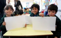 Children in a UBC classroom display a writing exercise on which they've been working.
