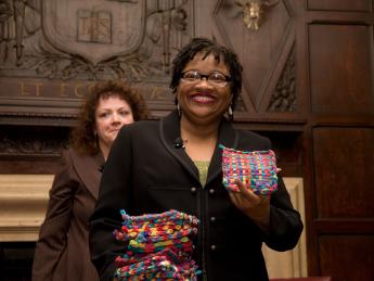 Beverly McIver with potholders made by her sister, Renée, at the Harvard Club of New York event. Filmmaker Jeanne Jordan is in the background.