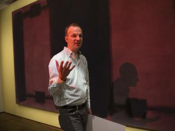Conservation scientist Jens Stenger explains the history of Mark Rothko’s <i>Harvard Murals</i> and the details of the conservation project in front of the now-faded <i>Panel Four.</i>