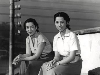 Two women seated looking into the film camera, from Japanese film Tokyo Story