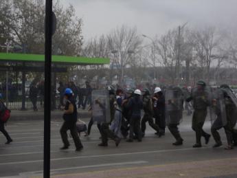 Chilean policemen detain students at a march in Santiago, Chile, in May 2012.