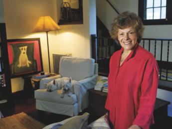 Ellen Langer at home, with her dogs and her own painting of a dog.