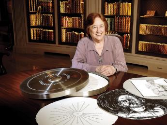Porter University Professor Helen Vendler in Houghton Library with a copy of the Arion Press edition of John Ashbery's "Self-Portrait in a Convex Mirror"
