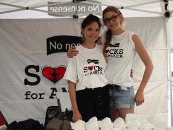 Rebecca Cooper (left) and Lily Erlinger at a Socks for America distribution event
