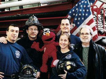 Four New York firefighters with John Weidman and <i>Sesame Street</i> character Elmo in 2001. 