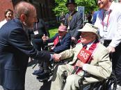 two men in wheelchairs are greeted
