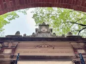 Harvard University entrance with inscription reading "Depart to Serve Better Thy Country and Thy Kind"