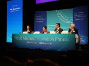 Panel discussion at the World Medical Innovation Forum with four speakers at a table.