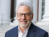 David Yoffie pictured smiling at the camera wearing a navy blazer