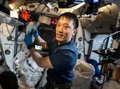 Astronaut performing an experiment inside the International Space Station.