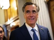 Mitt Romney in a suit, with a decorative background and natural lighting.
