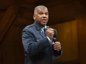 U.S. Air Force Lieutenant General Richard Clark in a military uniform speaks passionately into a microphone on stage.