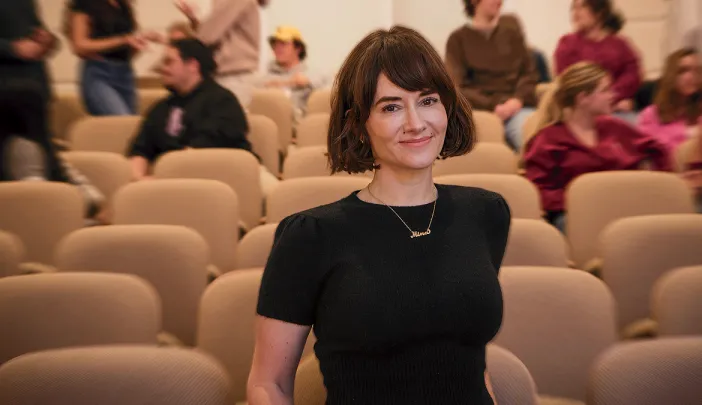 Mina Cikara in a classroom with two groups of students