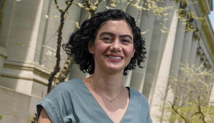 essay about the benefits of having a pet Susan Farbstein smiles while standing outside in front of a building with columns and surrounding greenery, wearing a light blue blouse.