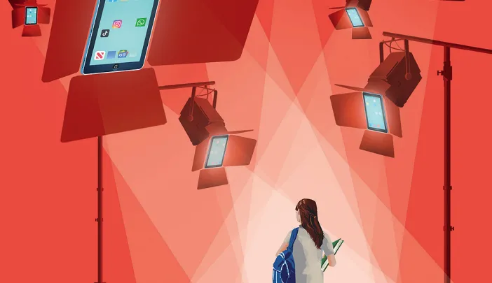 Student walking under bright stage lights shaped like smartphones displaying social media apps.