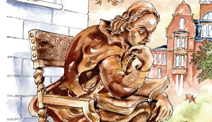 Bronze statue of a seated figure holding a book, with a campus setting in the background.